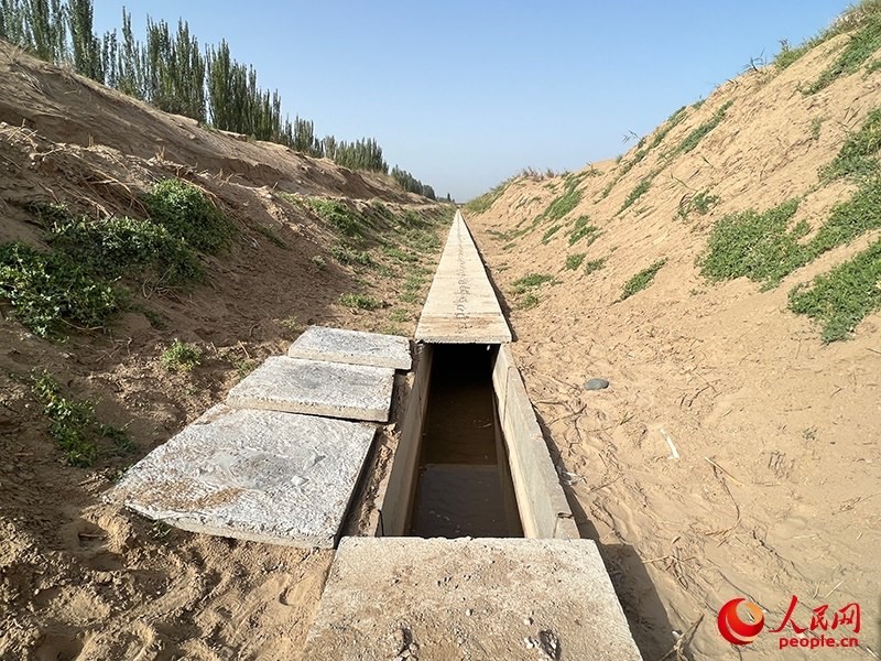 打開(kāi)蓋板，可見(jiàn)水在寬一米、深一米的渠道內(nèi)暢通流過(guò)。人民網(wǎng)記者 常雪梅攝