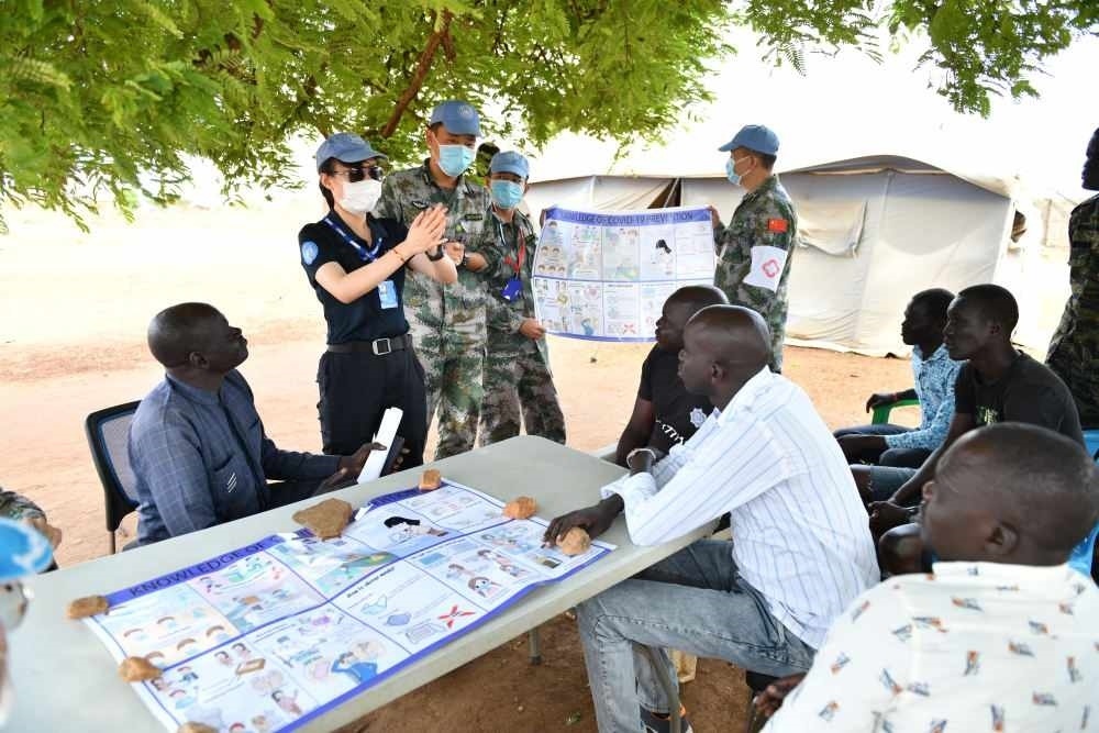 2020年3月，在南蘇丹首都朱巴，執(zhí)行聯(lián)合國維和任務(wù)的中國維和警察廖潔給當(dāng)?shù)鼐熘v解防疫知識。