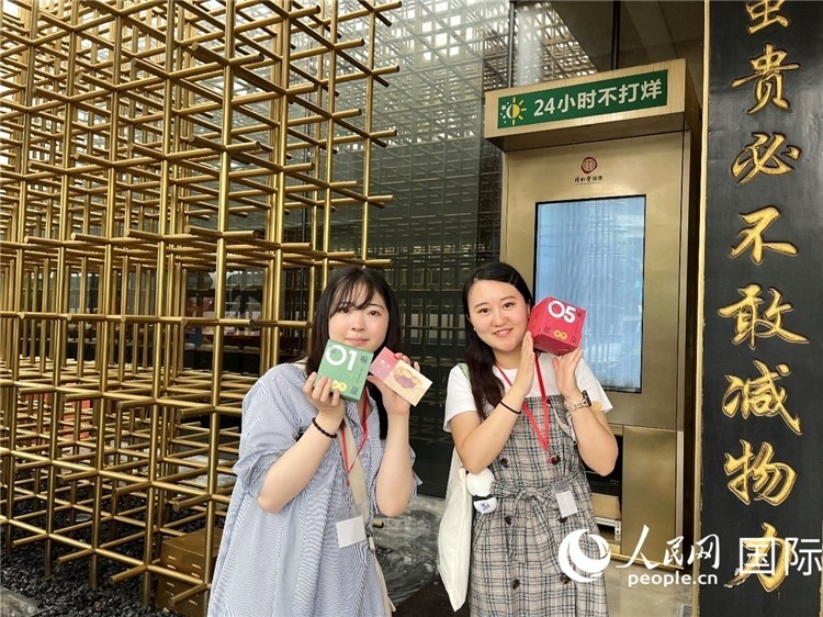 5. 代表團(tuán)團(tuán)員展示通過無(wú)人售藥機(jī)購(gòu)買的盲盒。（人民網(wǎng)記者陳思 攝）