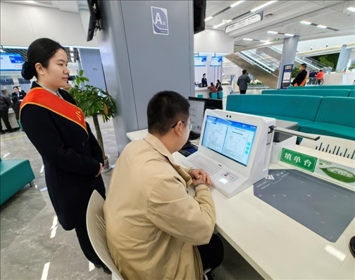 湖北省赤壁市市民在辦事人員的指導下填寫相關(guān)信息。圖片來源：人民網(wǎng)湖北頻道