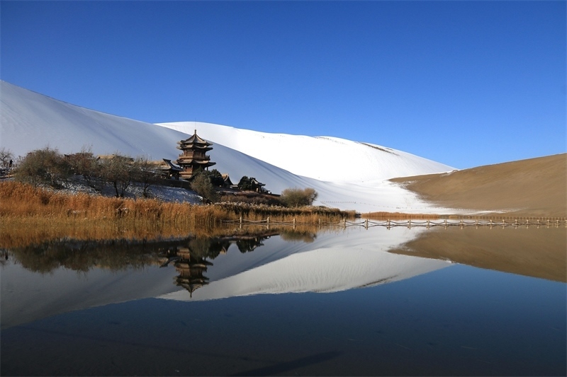 鳴沙山月牙泉景區(qū)雪景。敦煌市委宣傳部供圖，張曉亮攝