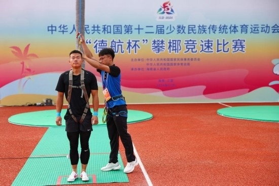11月23日，工作人員為上海隊(duì)選手付樂(lè)樂(lè)（左）系安全繩。新華社記者 楊植森 攝