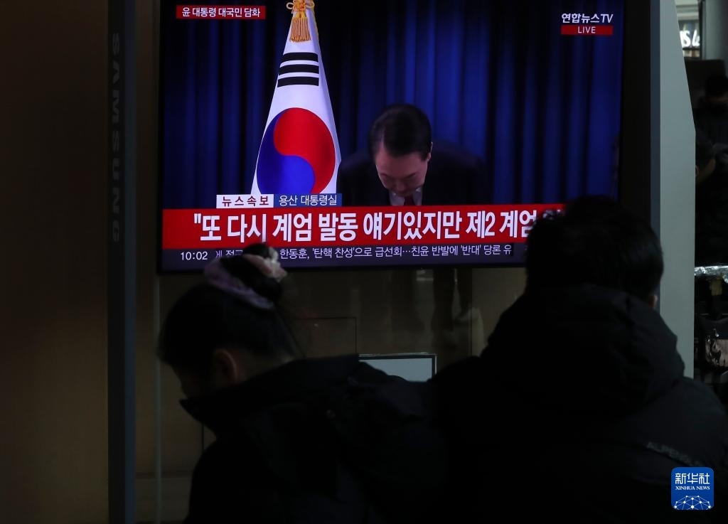 12月7日，在韓國首爾火車站，民眾觀看總統(tǒng)尹錫悅發(fā)表講話的電視畫面。新華社記者 姚琪琳 攝