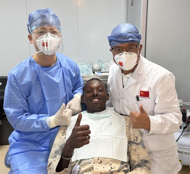 援吉醫(yī)療隊口腔科王瑋主任與“和平方舟”號醫(yī)院船醫(yī)務人員共同為一名當?shù)匮浪柩谆颊咴\療。中國（山西）第23批援吉布提醫(yī)療隊供圖